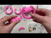 Assembling the pink HoD600 silicone cage to the back ring then locking it with a brass padlock.